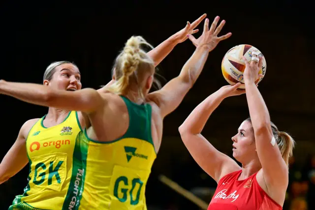 Cardwell is marked with ball in hand as she shoots.