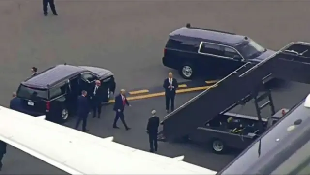 Former US President Donald Trump boards a plane bound for Washington DC