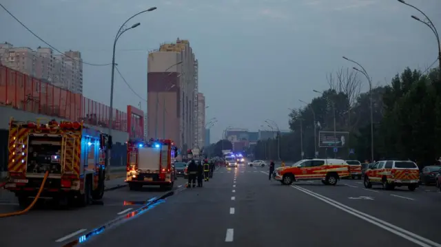 Fire engines gather around a building early in the morning