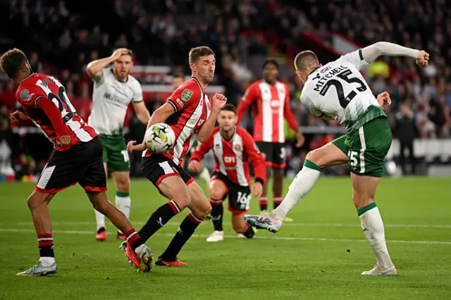 Alex Mitchell of Lincoln City takes a shot on goal during