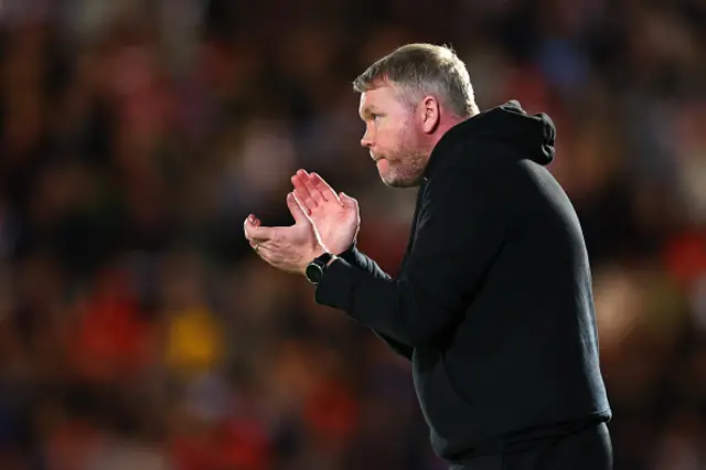 Grant McCann applauds on the touchline