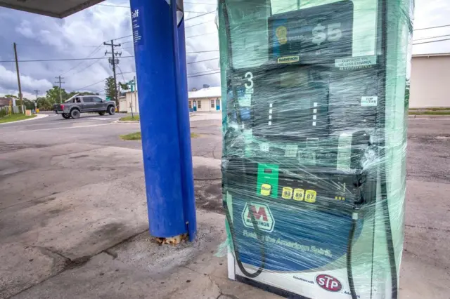 A gas station pump is wrapped in plastic as the town prepares for Hurricane Idalia in Cedar Key, Florida, USA, 29 August 2023