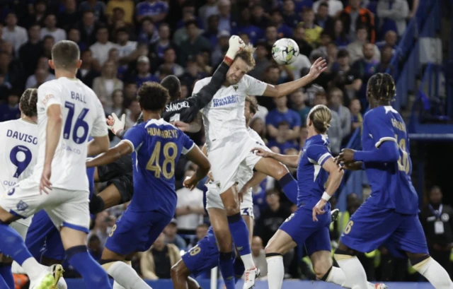 Chelsea's Robert Sanchez fouls AFC Wimbledon's Harry Pell to concede a penalty