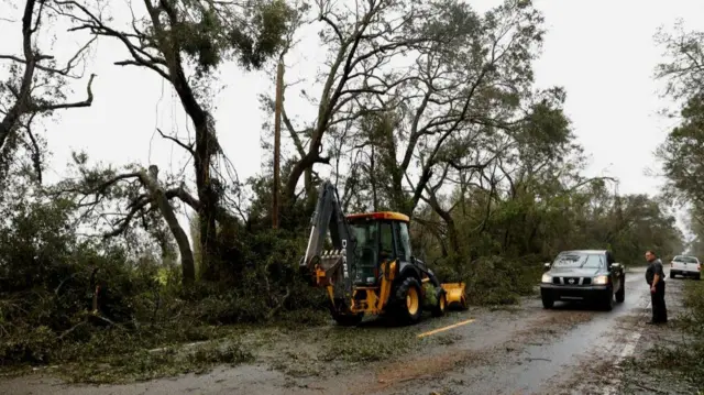 Workers clean the U.S. 27 between Mayo and Perry after the arrival of Hurricane Idalia, near Mayo, Florida, U.S., August 30, 2023. REUTERS/Marco Bello