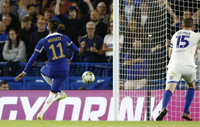 Chelsea's Noni Madueke scores their first goal from the penalty spot