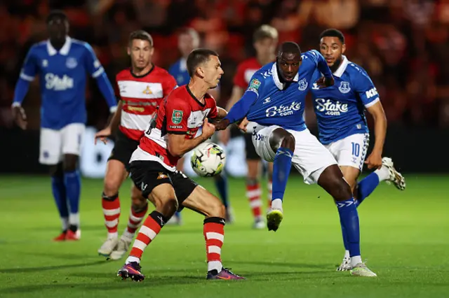 Zain Westbrooke of Doncaster Rovers and Abdoulaye Doucoure of Everton battle for the ball