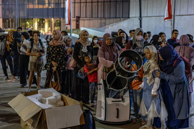 People queuing for big telescope in Jakarta