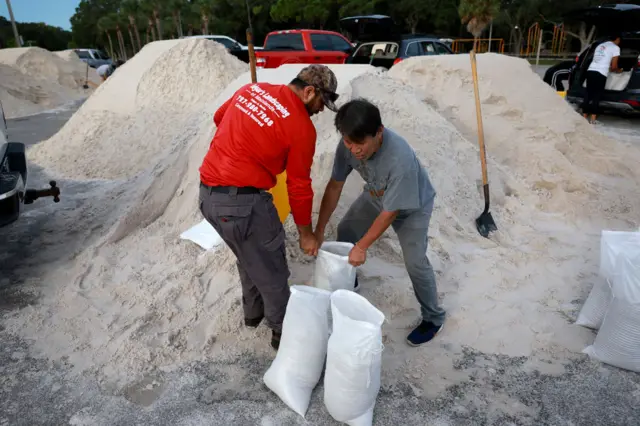 Edgar Rocha (L) and Paul Xy fill sandbags at the Helen S. Howarth Community Park ahead of the possible arrival of Hurricane Idalia on August 29, 2023 in Pinellas Park, Florida.