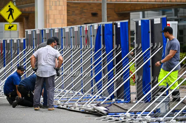 Workers set up a fence to prevent flooding at Tampa General Hospital earlier Tuesday