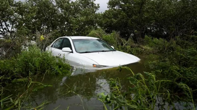 A vehicle is partially submerged after the arrival of Hurricane Idalia, in Cedar Key, Florida