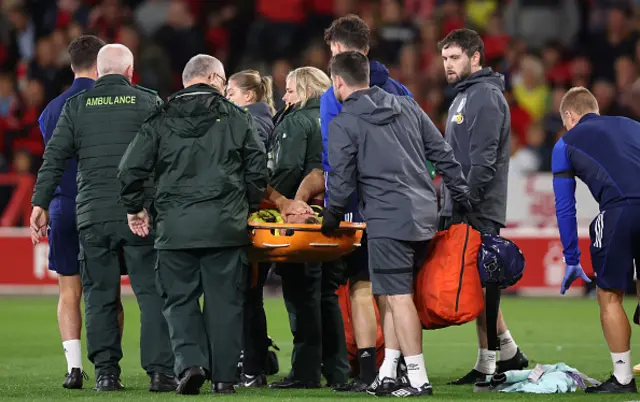 Hjalmar Ekdal of Burnley is stretchered off by medical staff