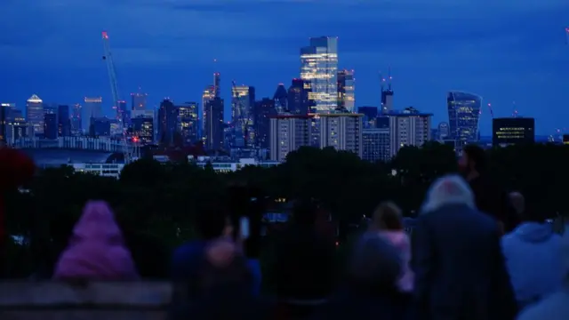 People gather on Primrose Hill in London in the hope of watching the super blue moon rise over the city