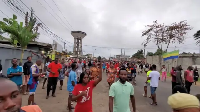 People walk through the street of Port-Gentil, Gabon