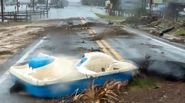 A road is full of debris and flooded in the town of Jena