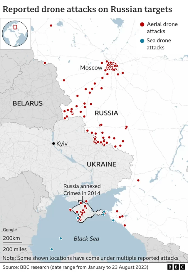 A map shows red and blue dots to show aerial and sea attacks on Russia. They mostly cluster along the border with Ukraine, over Moscow and in Crimea