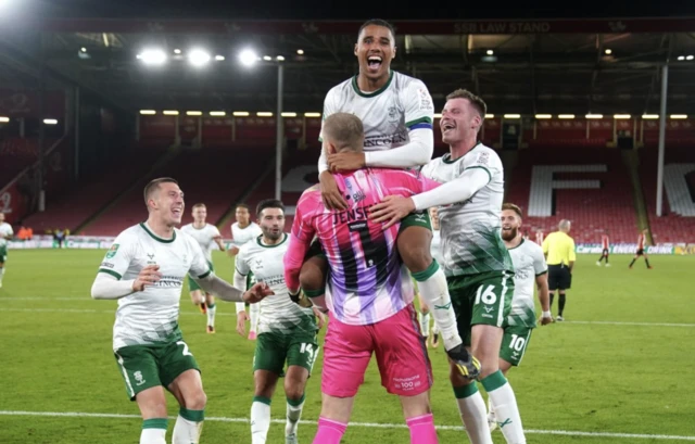 Lincoln City's Ethan Erhahon celebrates with team mates after the Carabao Cup