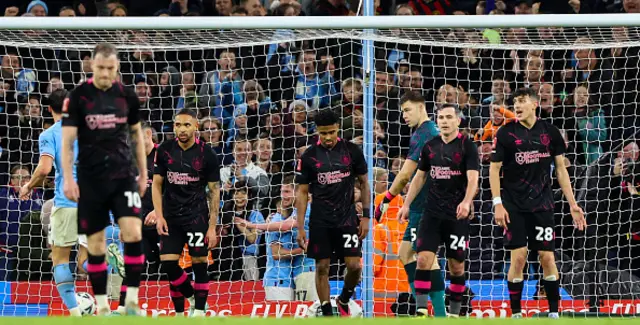 Burnley players look dejected after conceding against Manchester City