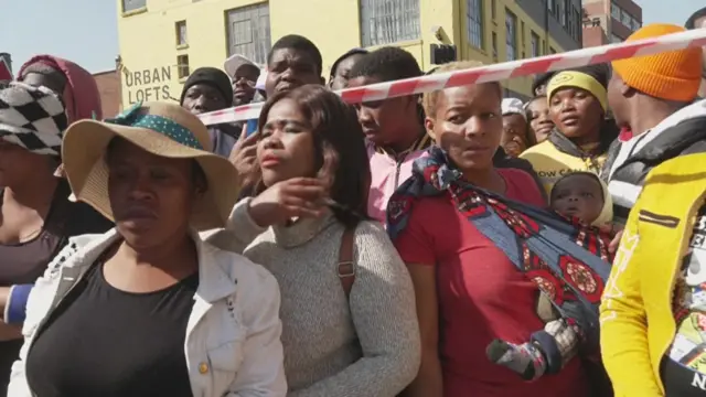 People waiting for news at the scene of the fire in Johannesburg