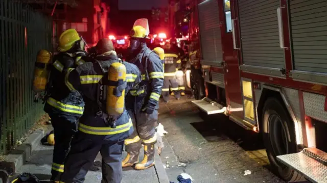 Firefighters on street outside the flats overnight