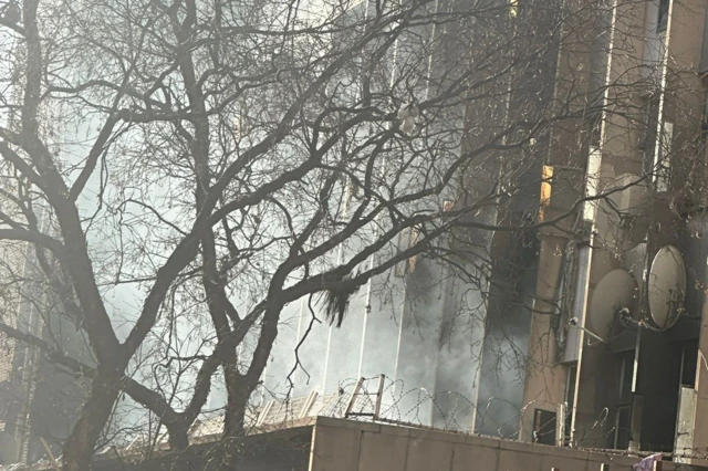 White smoke rises into the sky from a gutted building in Johannesburg