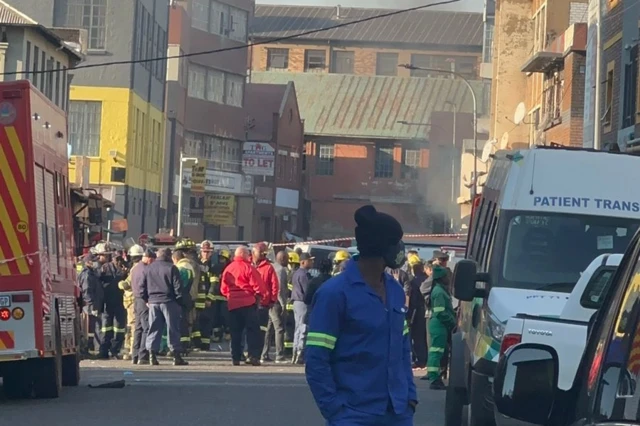 Emergency workers chat in groups in Johannesburg