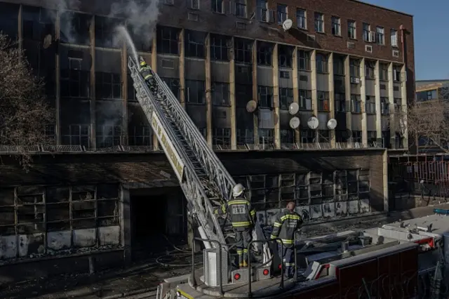 Firefighters at the scene of a blaze at a five-storey block in Johannesburg