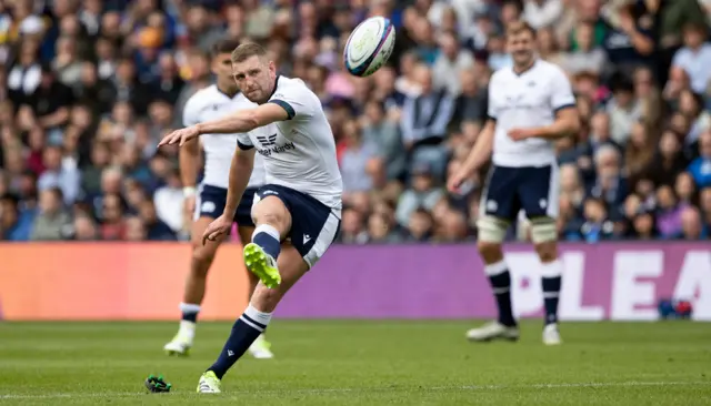 Finn Russell kicks at goal