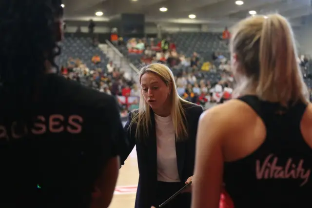 Jess Thirlby stands in front of her players to give instructions.