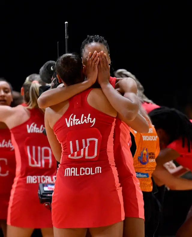 England players hug in delight after their huge win.