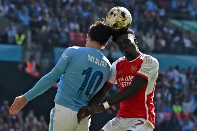 Bukayo Saka challenges Jack Grealish