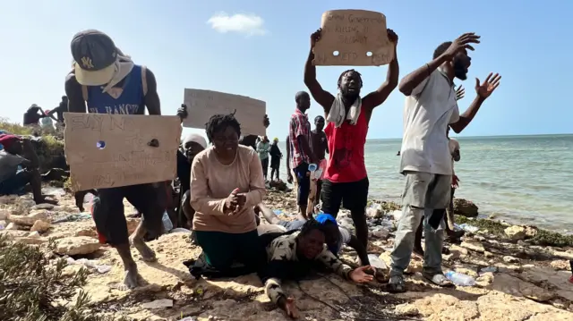 Sub-Saharan African migrants who were expelled from the city of Sfax in Tunisia beg for help as they gather in an area near the Libyan-Tunisia border, in Ras Jedir, 173 km west of Tripoli, Libya, 26 July 2023.