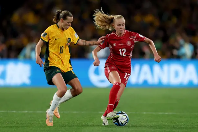 Katherine Kuhl dribbles away from Emily van Egmond.