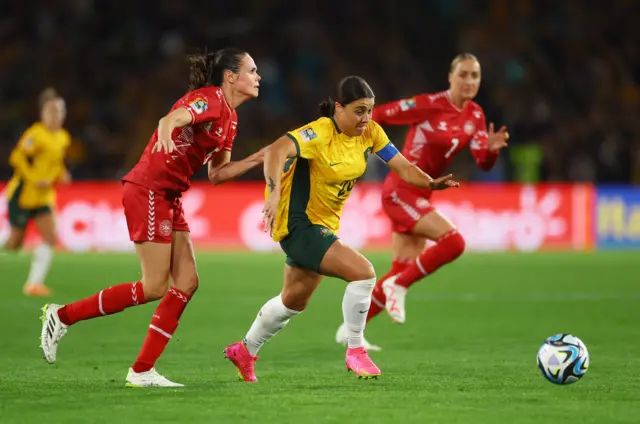 Sam Kerr races forward with the ball.