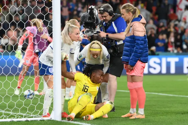 Chiamaka Nnadozie of Nigeria is consoled by England players after the FIFA Women's World Cup