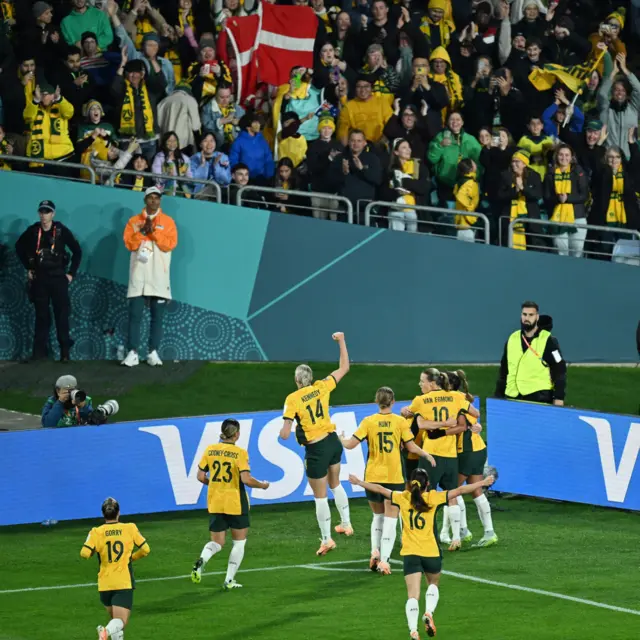 Australia celebrate their opening goal in the corner with the fans.