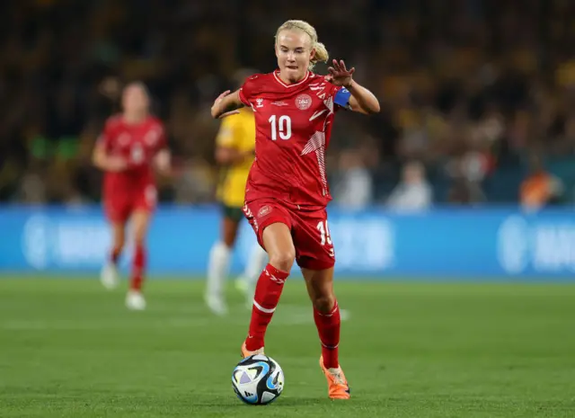 Pernille Harder dribbles forward with the ball.