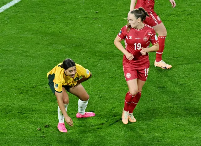 Sam Kerr gets back to her feet after an awkward fall.