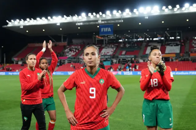 Morocco players stand and take in the applause from the fans.