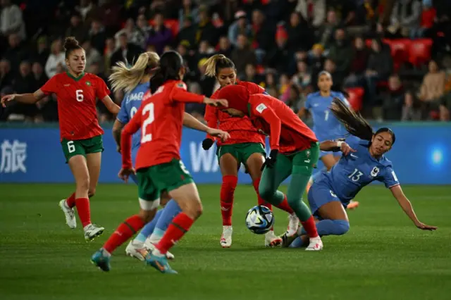 Benzina stands tall for Morocco winning the ball off Dali.