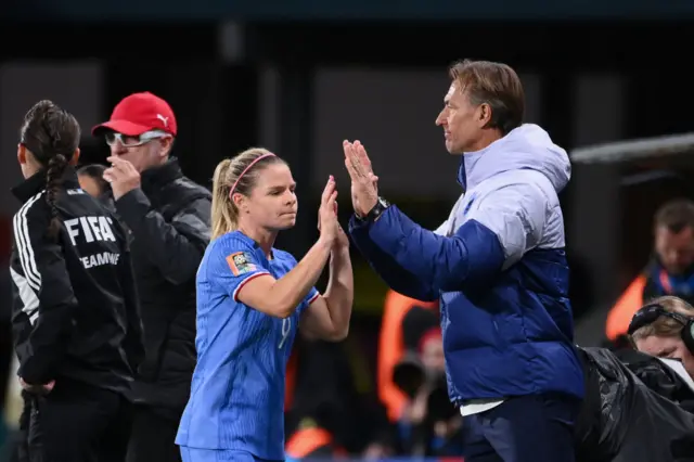 Herve Renard high fives Le Sommer after she is subbed off.