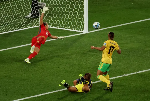 Santos dives to head towards goal at the back post.