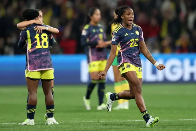 Colombia players run on the pitch to celebrate.