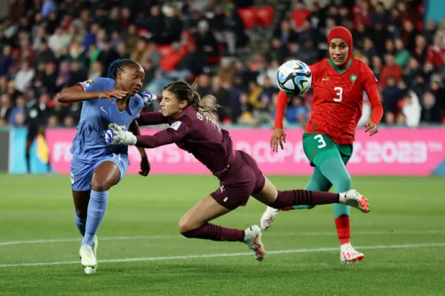 Diani is challenged by the on-rushing Morocco keeper.