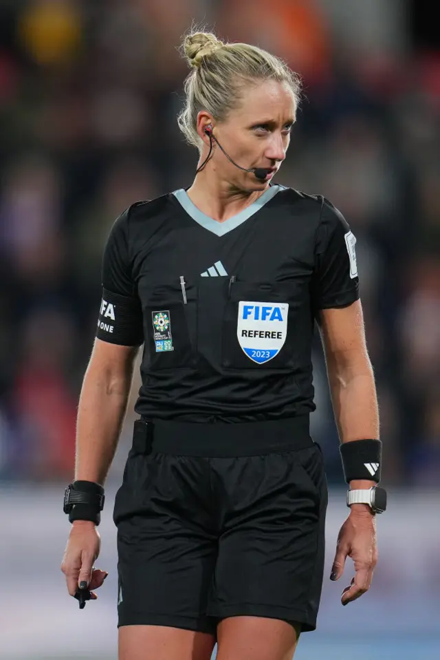 The referee stares down El Haj after another risky challenge.