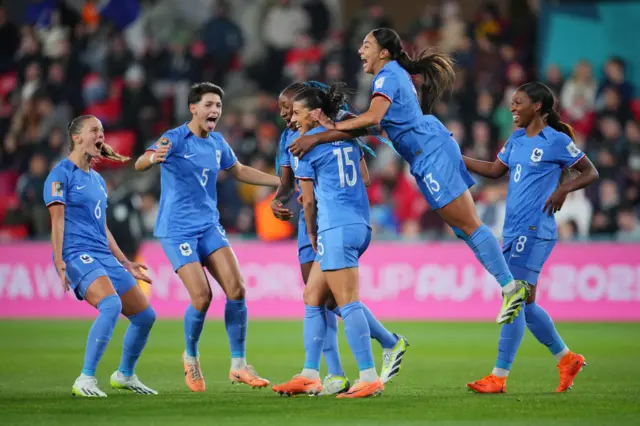 France players flock to Dali after she scores their second.