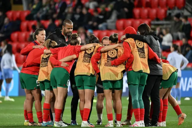Morocco players huddle together on the pitch before the pre-match warm ups.