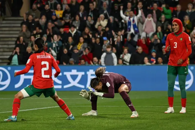 Morocco players thump the ground in frustration after France score their third.