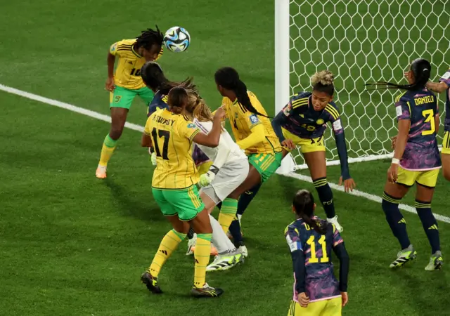 Brown heads towards goal in a crowded penalty area.