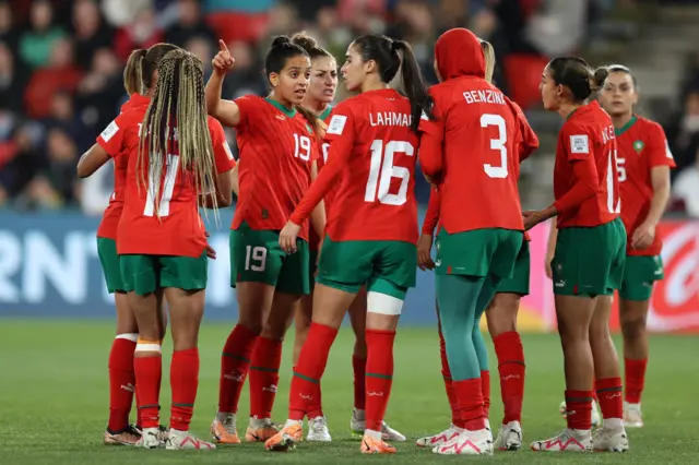 Morocco players stand and launch an inquisition after conceding a third goal.