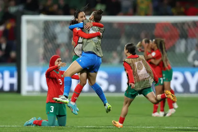 Morocco players celebrate wildly after getting through the group stage.